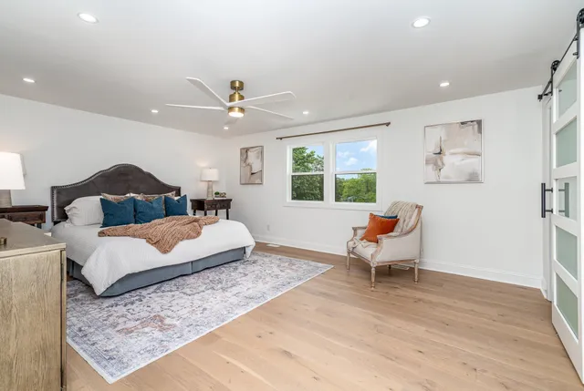 a bedroom with a bed and wooden floor