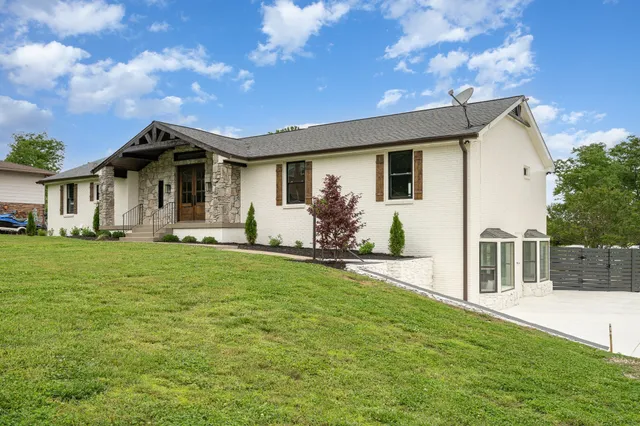 a front view of house with yard and green space