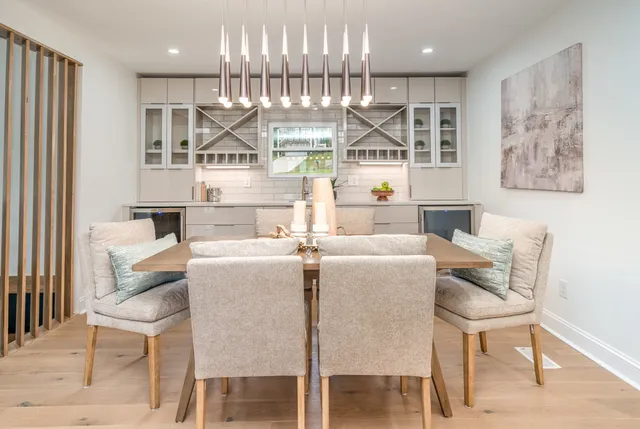 a living room with furniture a table and kitchen view