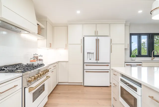 a kitchen with stainless steel appliances a refrigerator sink and cabinets