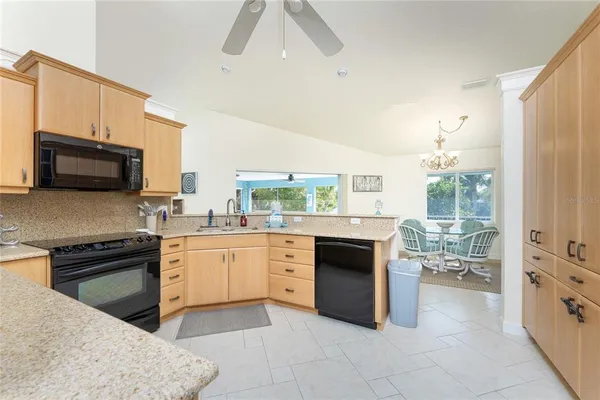 a spacious bedroom with a bed and a ceiling fan