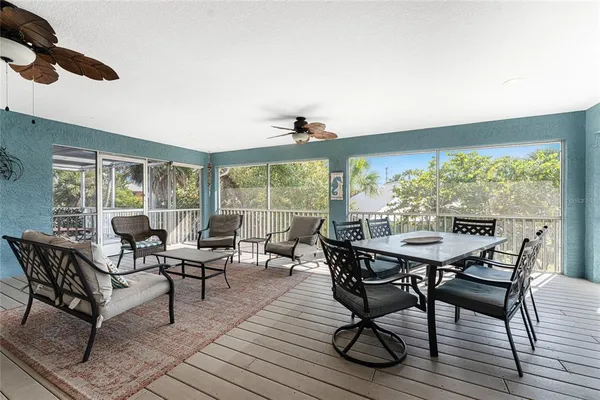 a kitchen with stainless steel appliances granite countertop a stove top oven a sink a stove a dining table and chairs