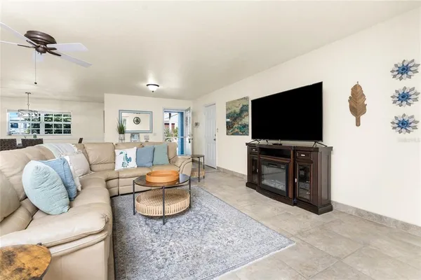 a dining room with furniture water view and a floor to ceiling window