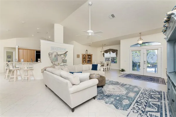a living room with furniture and a chandelier