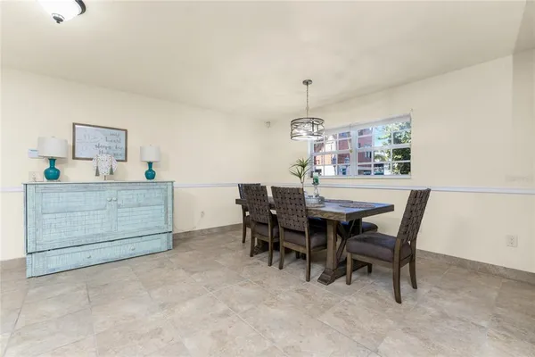 a view of a dining room with furniture water view and a chandelier