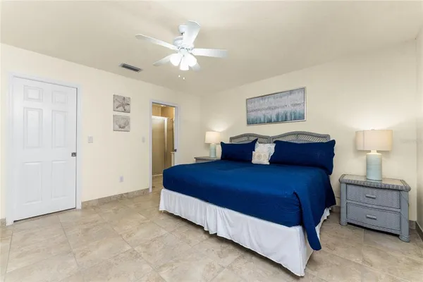 a living room with patio furniture and a floor to ceiling window