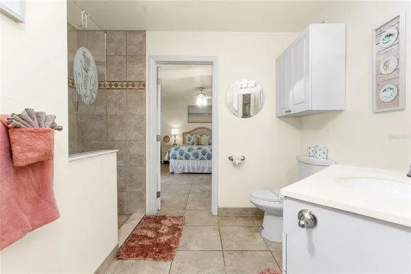 an aerial view of ocean and residential houses with outdoor space