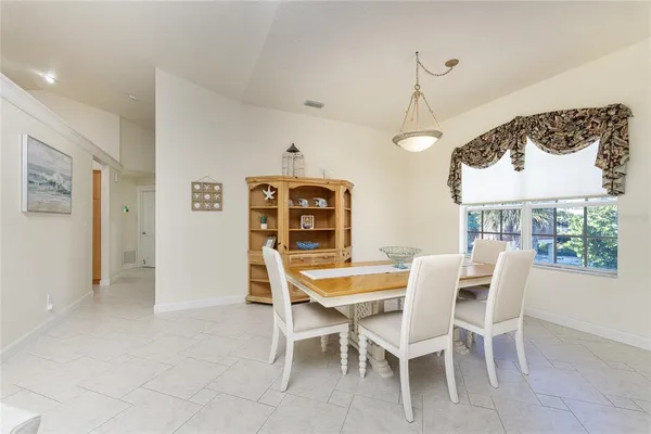 a dining room with furniture and window
