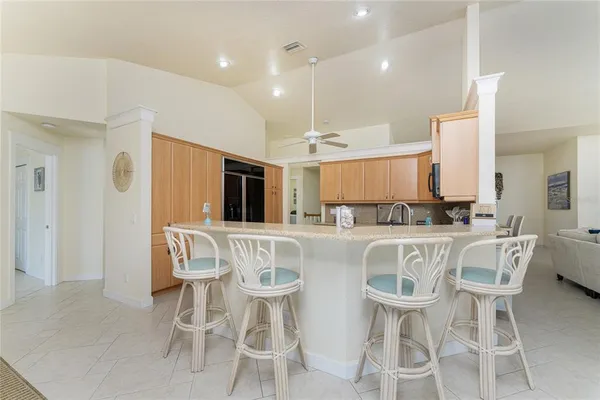 a kitchen with granite countertop a stove top oven microwave and cabinets