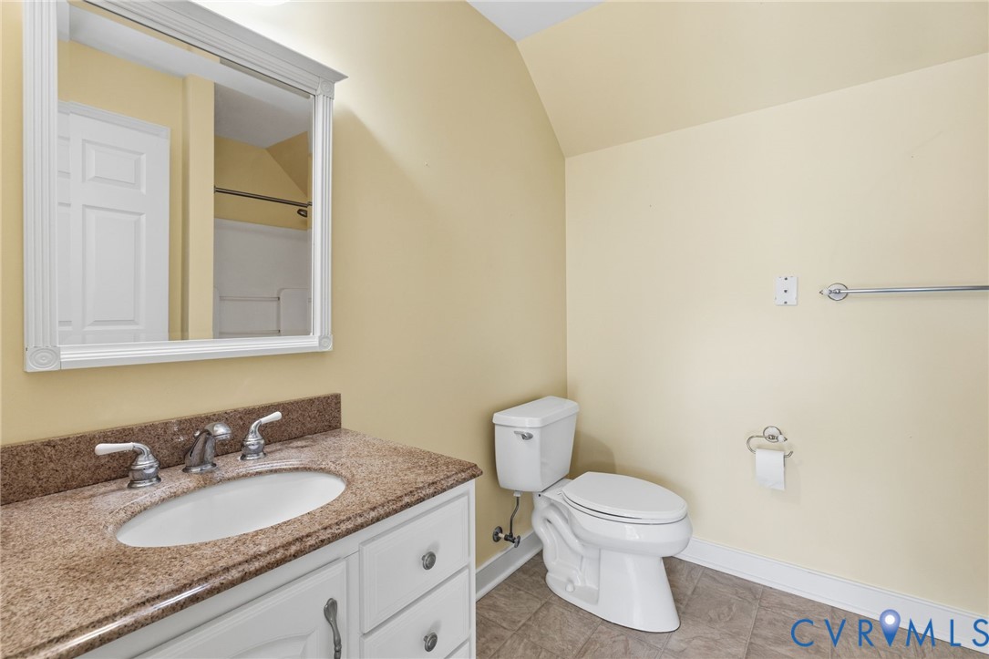 15441 Goshen Road Montpelier, VA 23192 - Photo 39 of 47 a bathroom with a granite countertop toilet a sink and a mirror