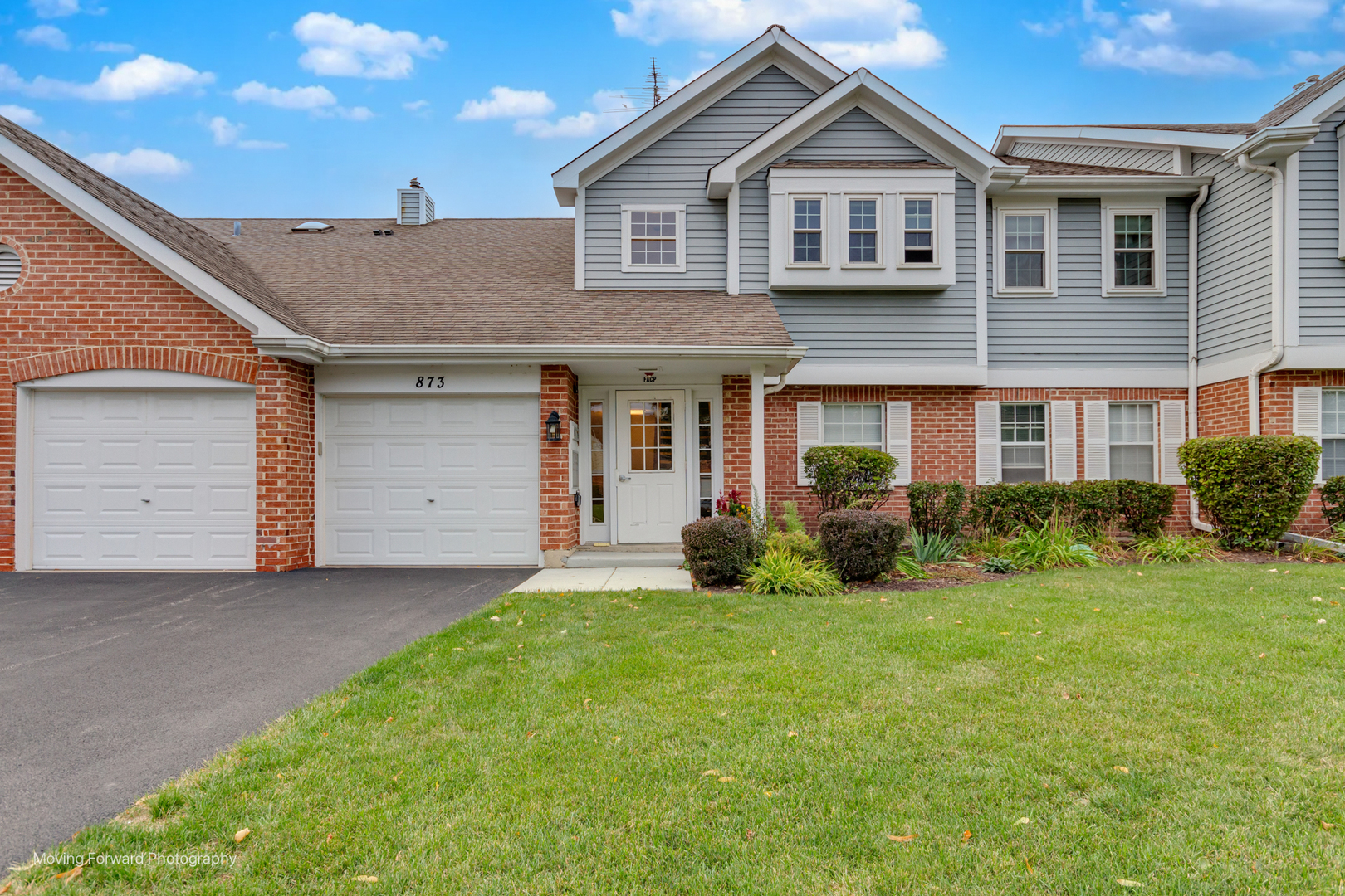 873 Quin Court, Unit 202 Naperville, IL 60563 - Photo 1 of 1 a front view of a house with a garden and yard