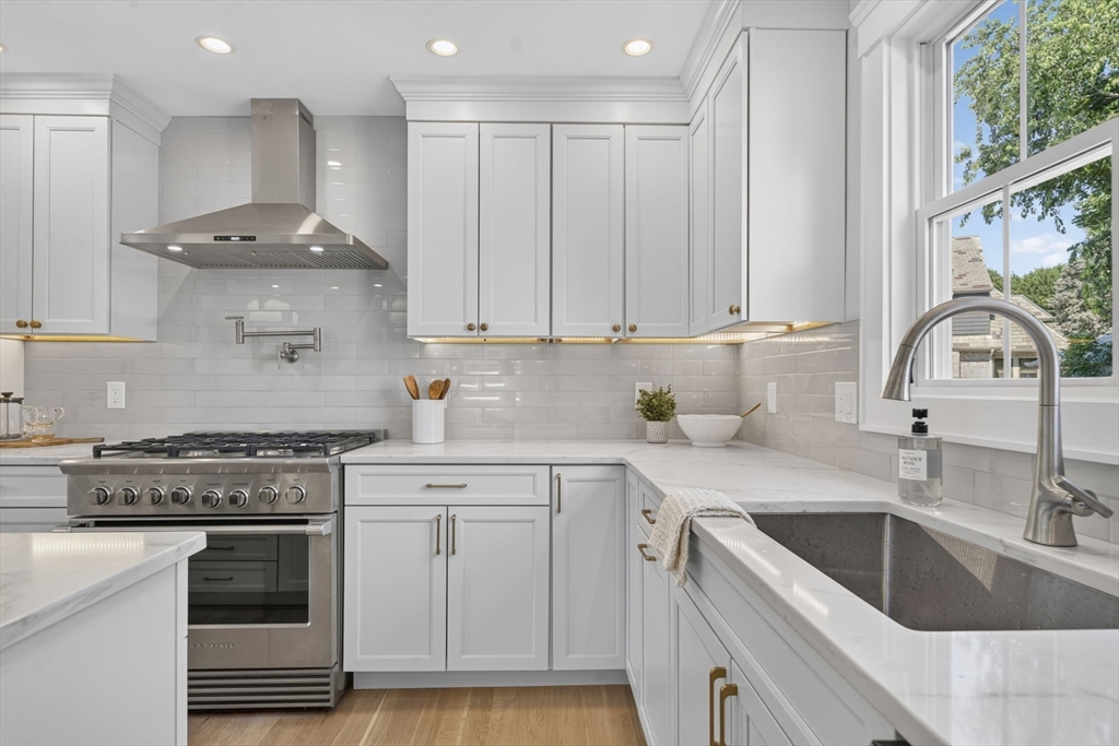 20 Saltonstall Road Medford, MA 02155 - Photo 10 of 41 a kitchen with a sink white cabinets and white appliances