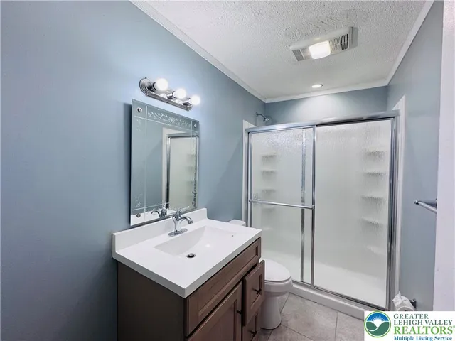 a bathroom with a sink a mirror and a shower
