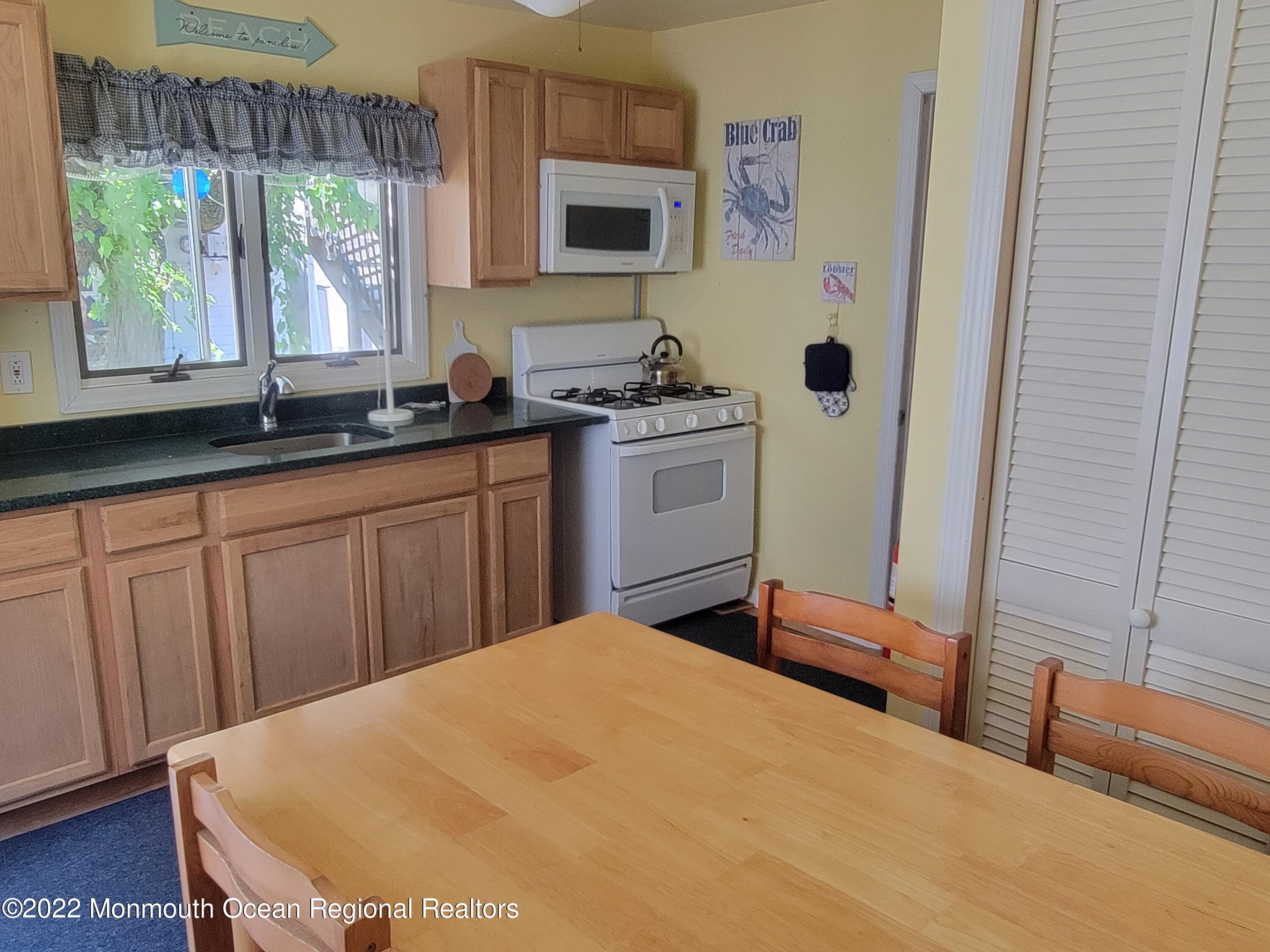 110 5th Avenue Seaside Park, NJ 08752 - Photo 11 of 25 a bedroom with a bed and a window