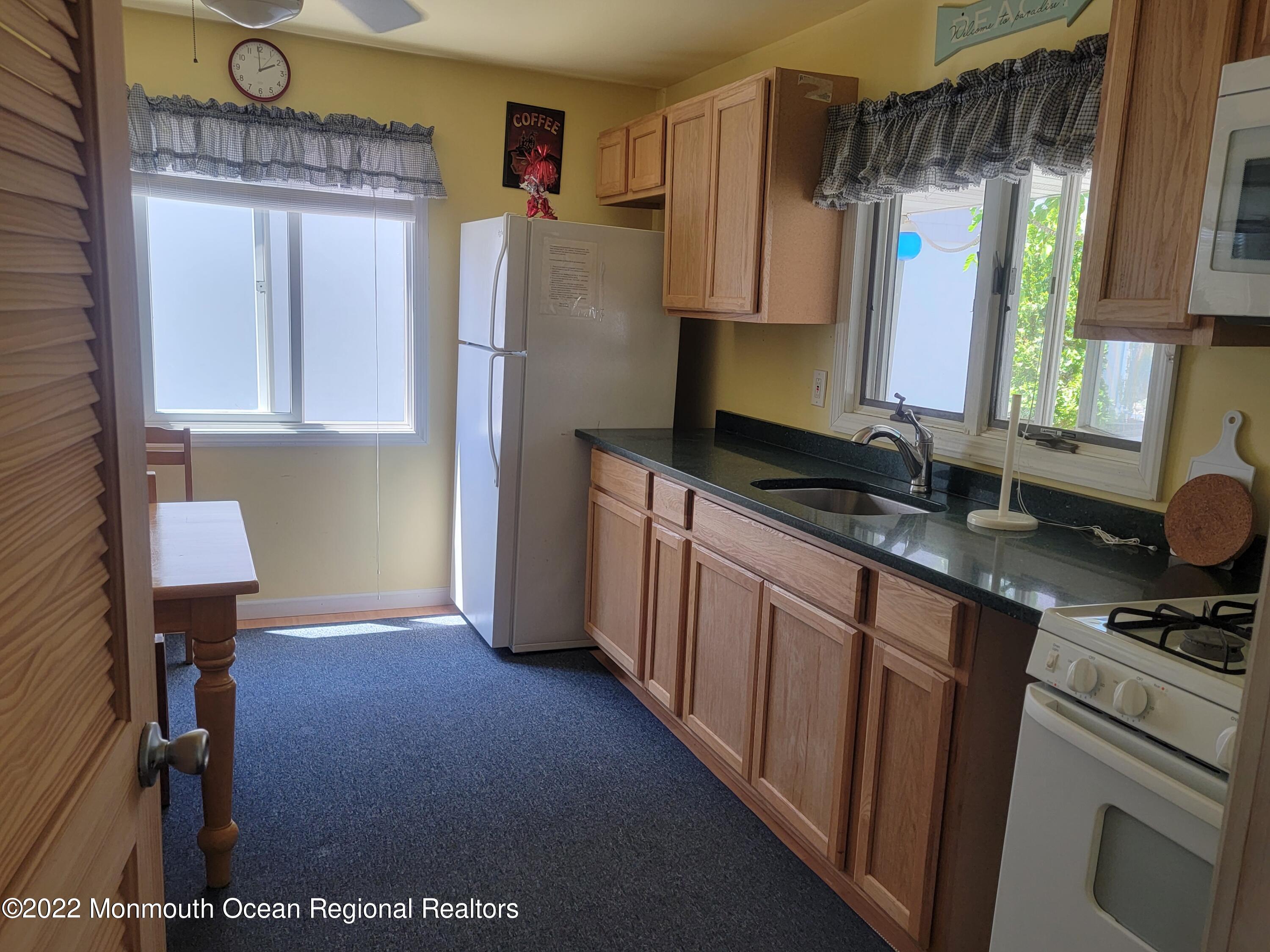 110 5th Avenue Seaside Park, NJ 08752 - Photo 14 of 25 a kitchen with stainless steel appliances granite countertop a sink stove and refrigerator