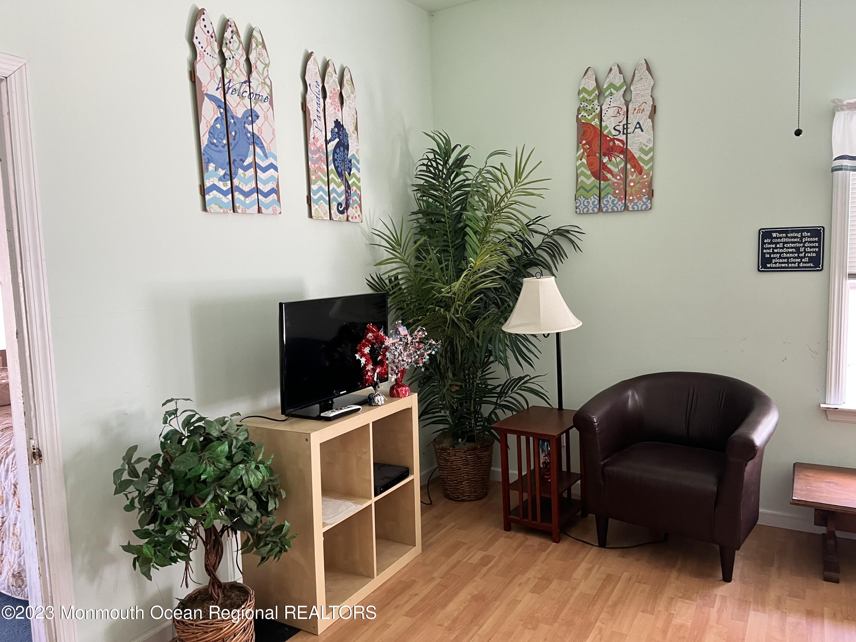 110 5th Avenue Seaside Park, NJ 08752 - Photo 17 of 25 a living room with furniture and a potted plant