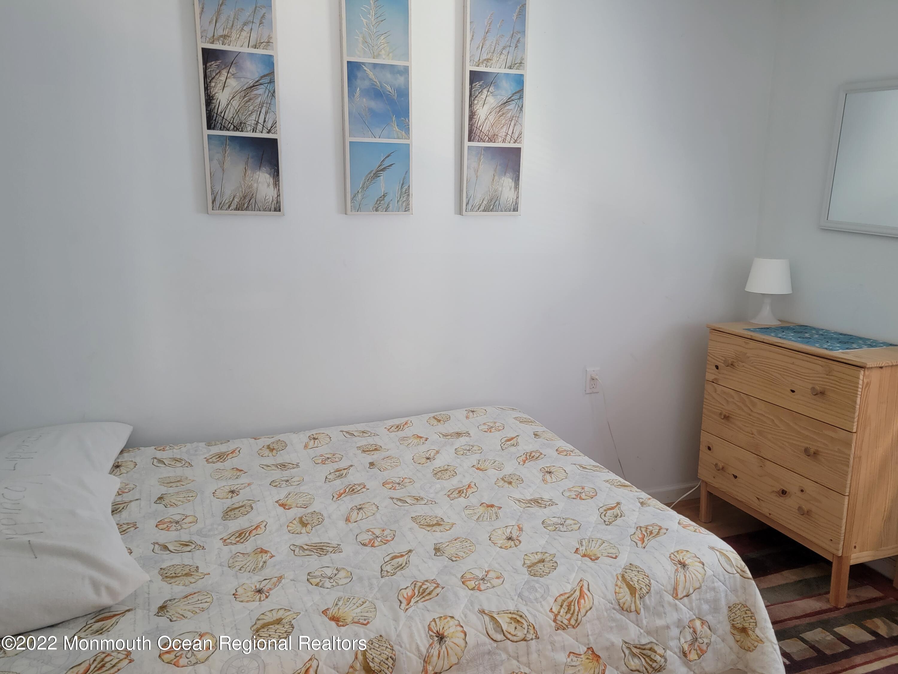 110 5th Avenue Seaside Park, NJ 08752 - Photo 21 of 25 a bedroom with a bed and cabinets