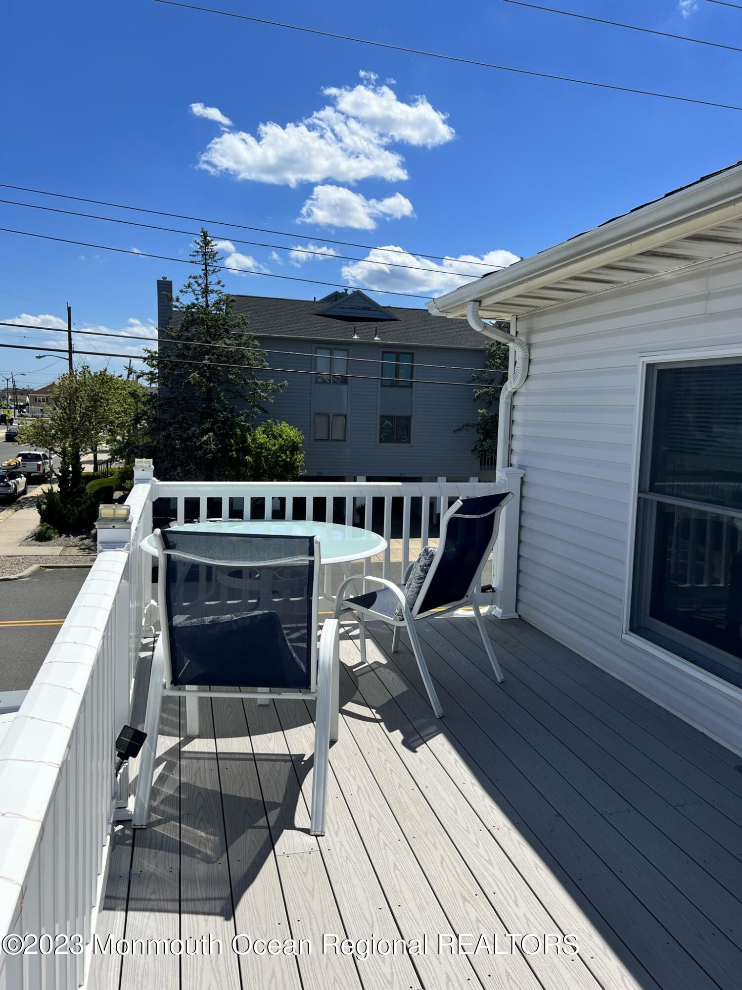 110 5th Avenue Seaside Park, NJ 08752 - Photo 7 of 25 a view of a roof deck with table and chairs a barbeque with wooden floor and a yard