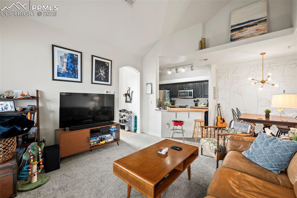5378 Palomino Ranch Point, Unit 201 Colorado Springs, CO 80922 - Photo 11 of 15 a living room with furniture and a flat screen tv