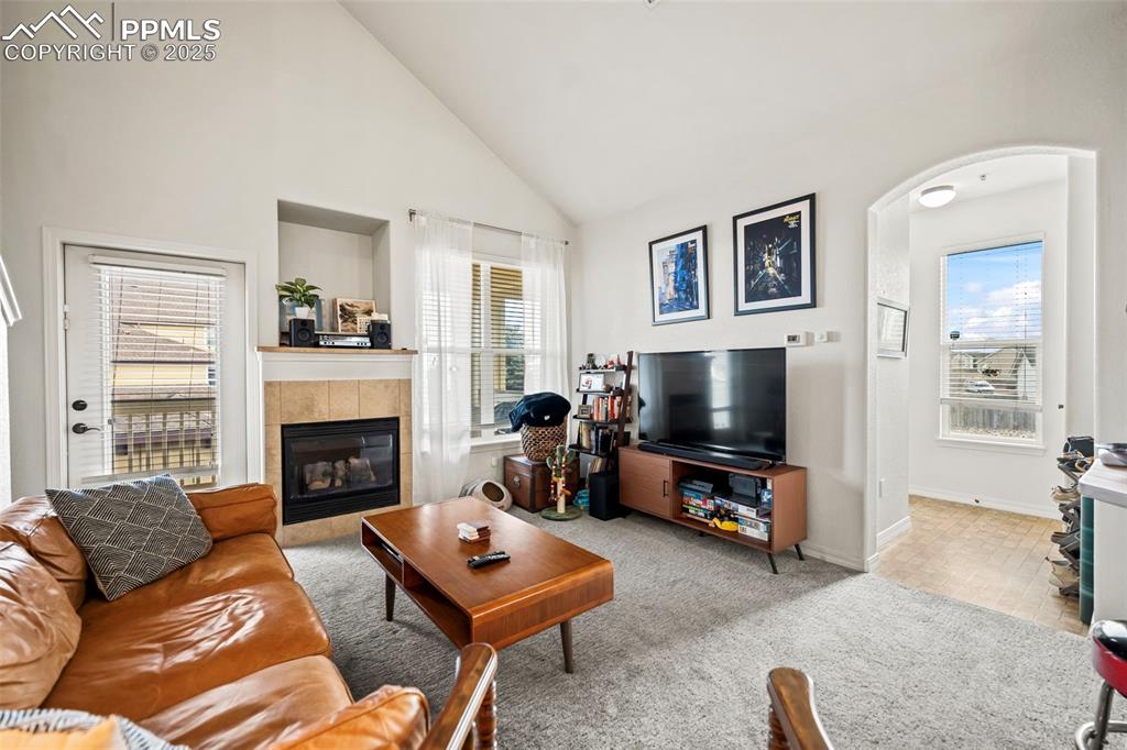 5378 Palomino Ranch Point, Unit 201 Colorado Springs, CO 80922 - Photo 2 of 15 a living room with furniture a flat screen tv and a fireplace