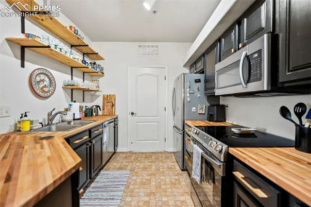 a kitchen with stainless steel appliances granite countertop a stove and a sink