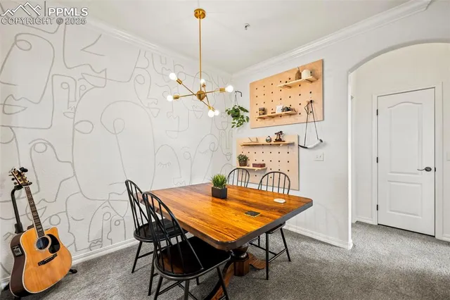 a view of a room that has a table and chairs in it