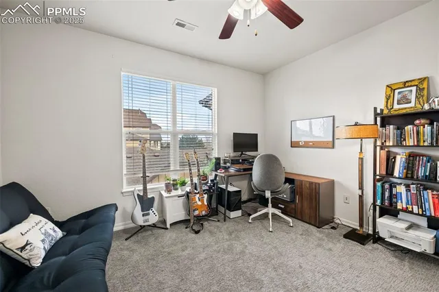 a view of a livingroom with workspace and a window