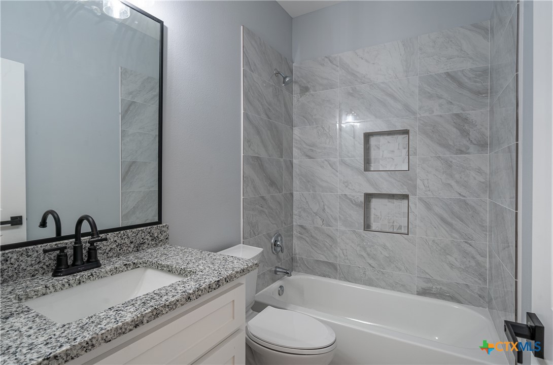 1000 Black Ankle Road Lockhart, TX 78644 - Photo 25 of 40 a bathroom with a granite countertop sink toilet and shower