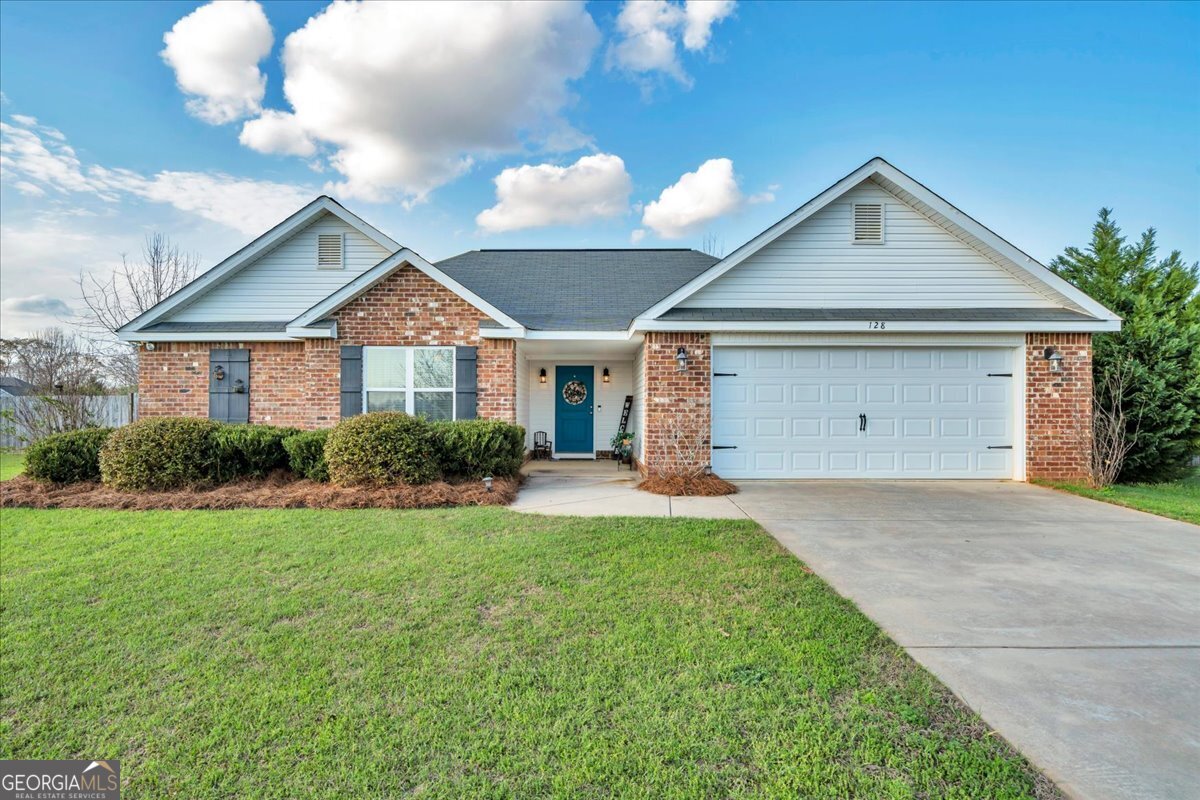 a front view of house a yard and garage