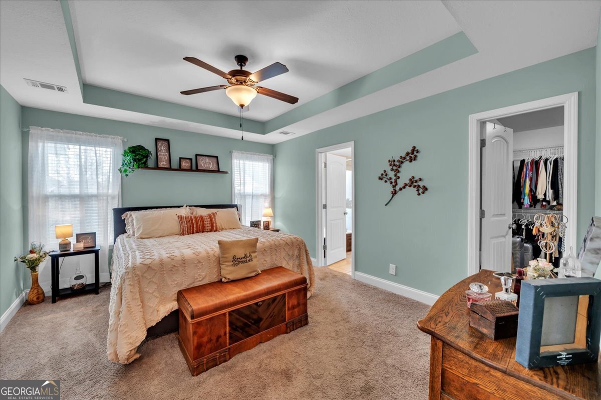 128 Gage Drive Perry, GA 31069 - Photo 14 of 38 a bed room with a bed and a chandelier