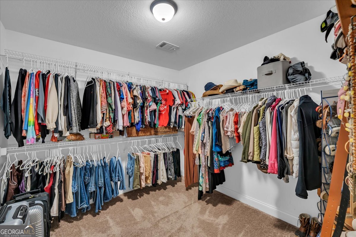 128 Gage Drive Perry, GA 31069 - Photo 17 of 38 a view of walk in closet with clothes