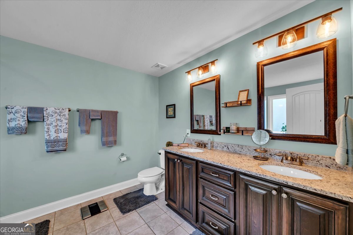128 Gage Drive Perry, GA 31069 - Photo 18 of 38 a bathroom with a sink and a mirror