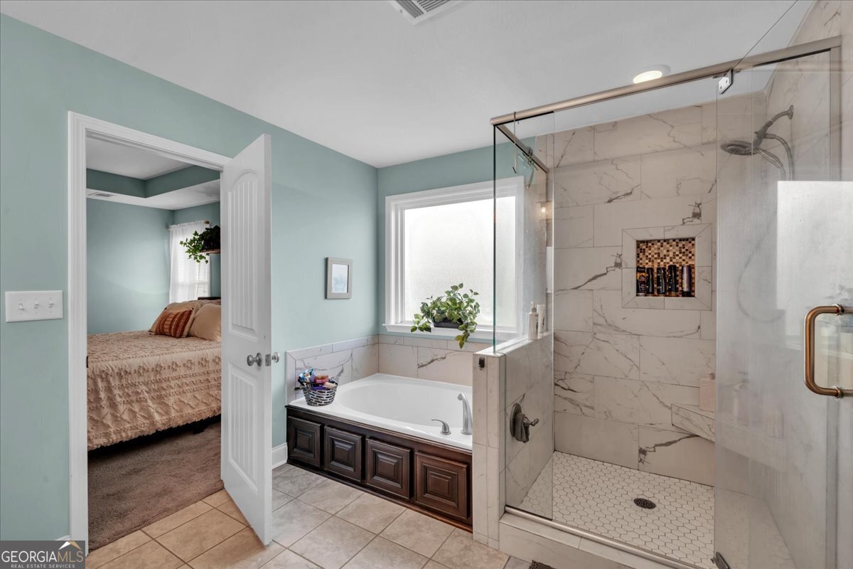 128 Gage Drive Perry, GA 31069 - Photo 19 of 38 a bathroom with a tub shower vanity and sink