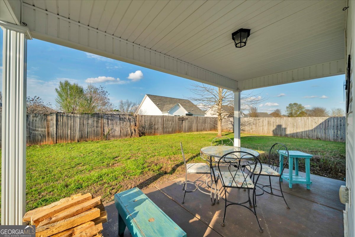 128 Gage Drive Perry, GA 31069 - Photo 27 of 38 a view of an outdoor dining space with furniture and backyard