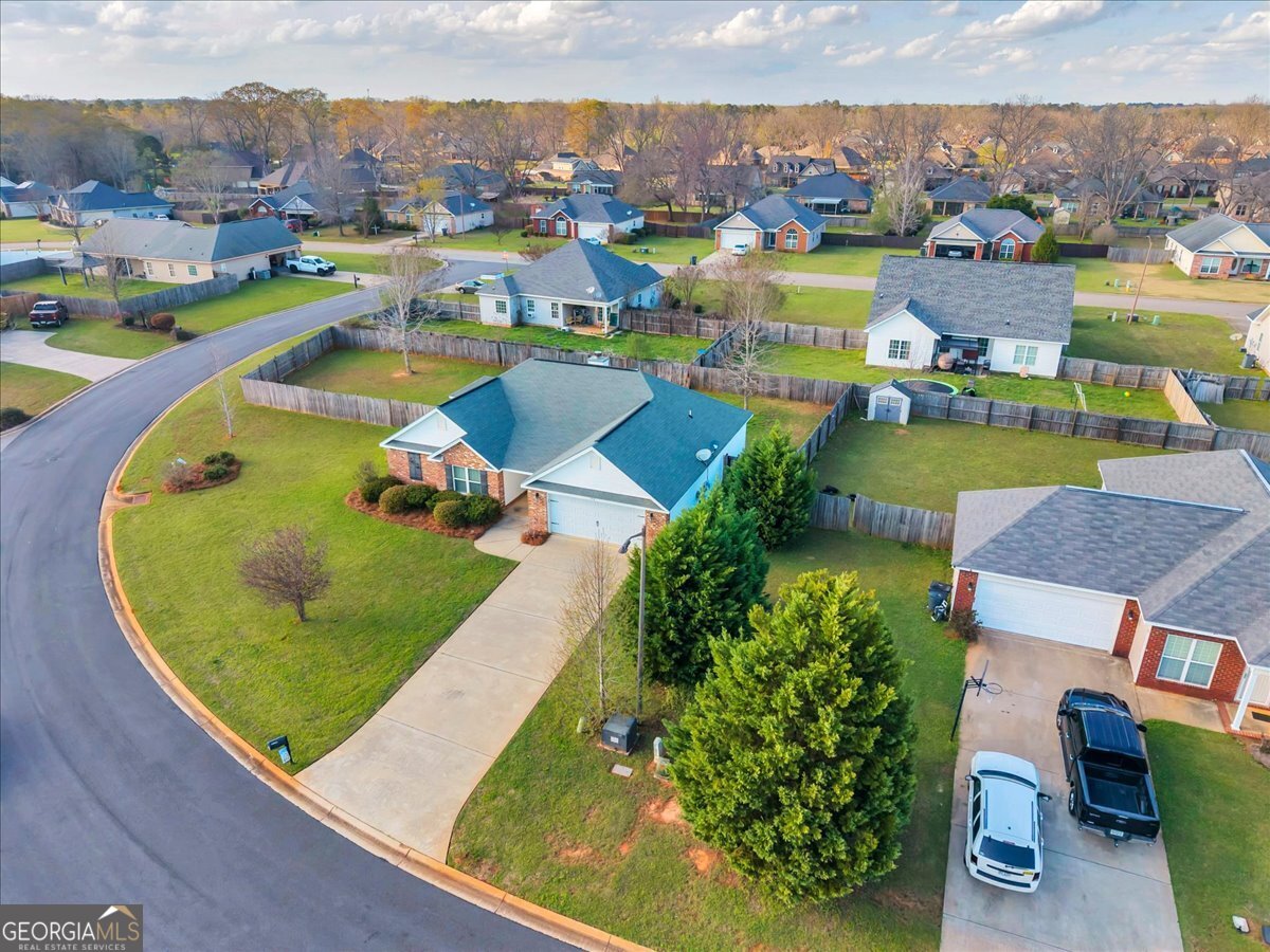 128 Gage Drive Perry, GA 31069 - Photo 34 of 38 an aerial view of a house with a garden and lake view