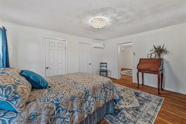 a bedroom with a bed and a table in it