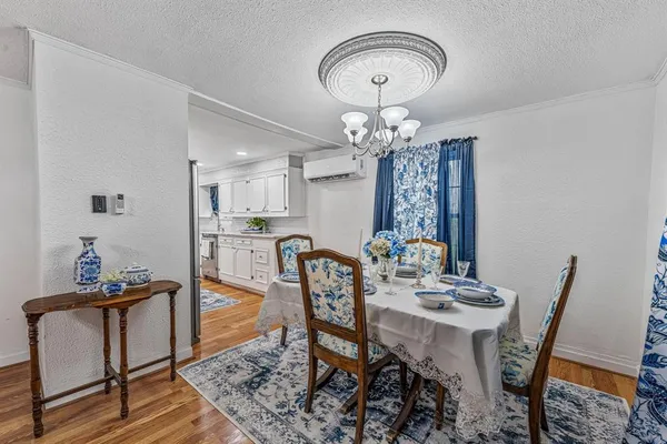a view of a dining room with furniture and chandelier