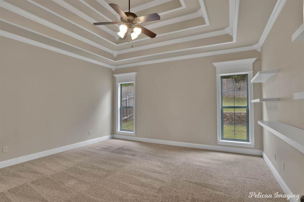 346 Wood Springs Haughton, LA 71037 - Photo 12 of 25 Carpeted spare room with a tray ceiling, a ceiling fan, and crown molding