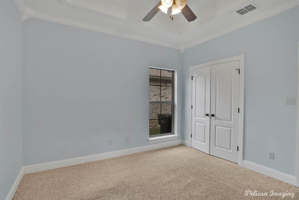 346 Wood Springs Haughton, LA 71037 - Photo 17 of 25 Unfurnished bedroom featuring carpet, crown molding, a closet, and ceiling fan