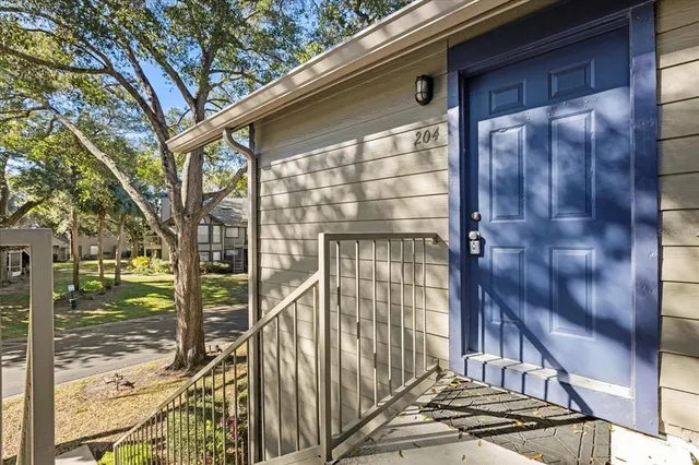 a view of an empty room with a window and a fireplace