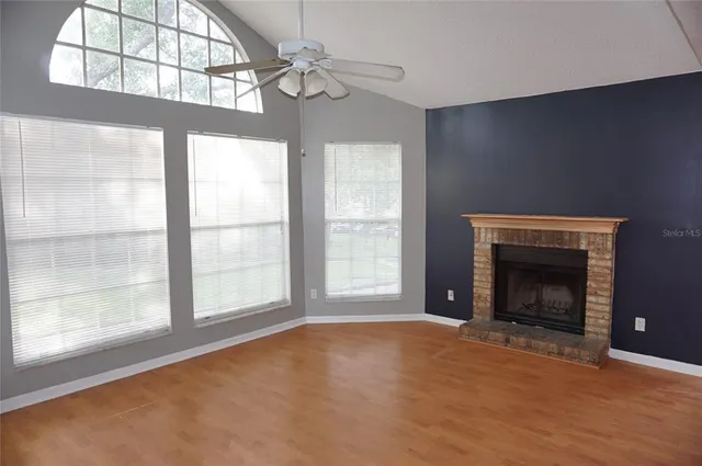 a view of an empty room with a fireplace