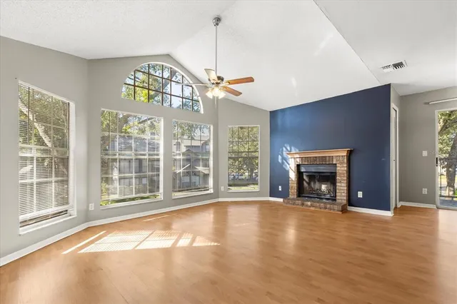 a view of empty room with window and fireplace