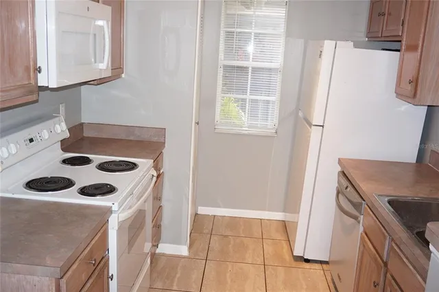 a kitchen with a refrigerator and a stove