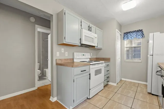 a kitchen that has a sink and a stove in it