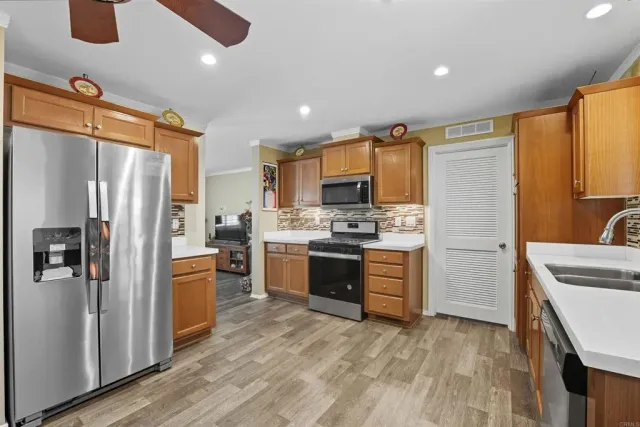 a kitchen with a refrigerator stove and sink