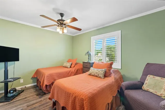 a bedroom with two beds and a window