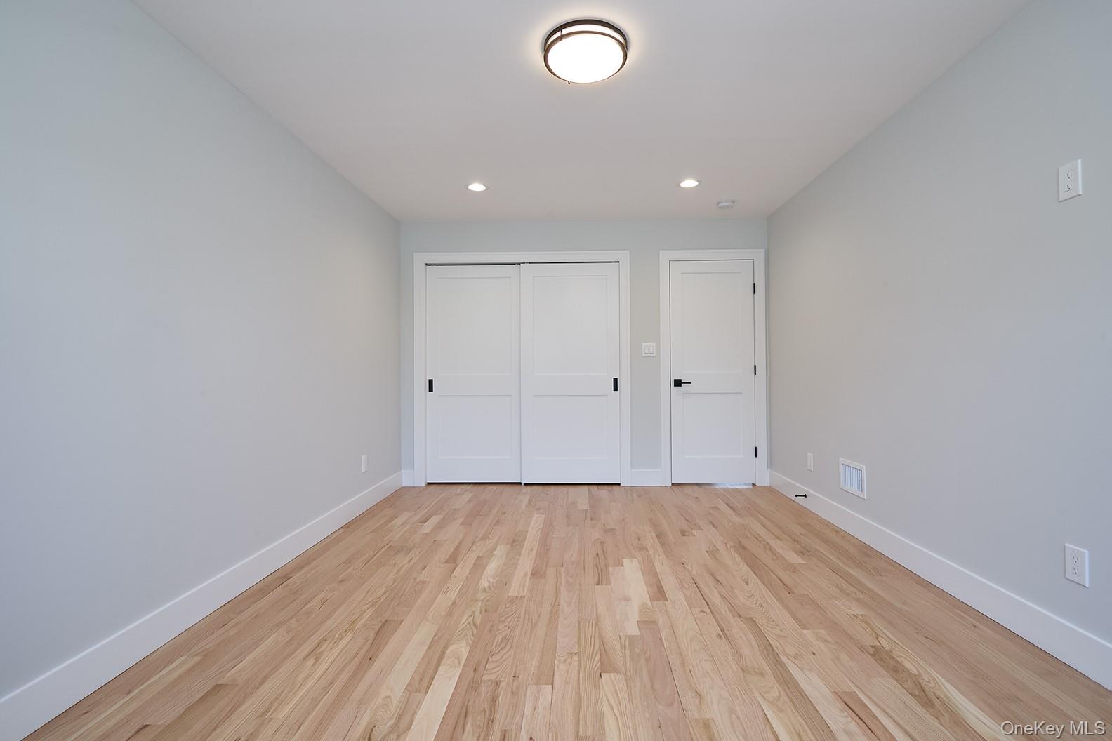 1480 Adam Place Wantagh, NY 11793 - Photo 19 of 22 Unfurnished bedroom with light wood-type flooring, recessed lighting, and a closet