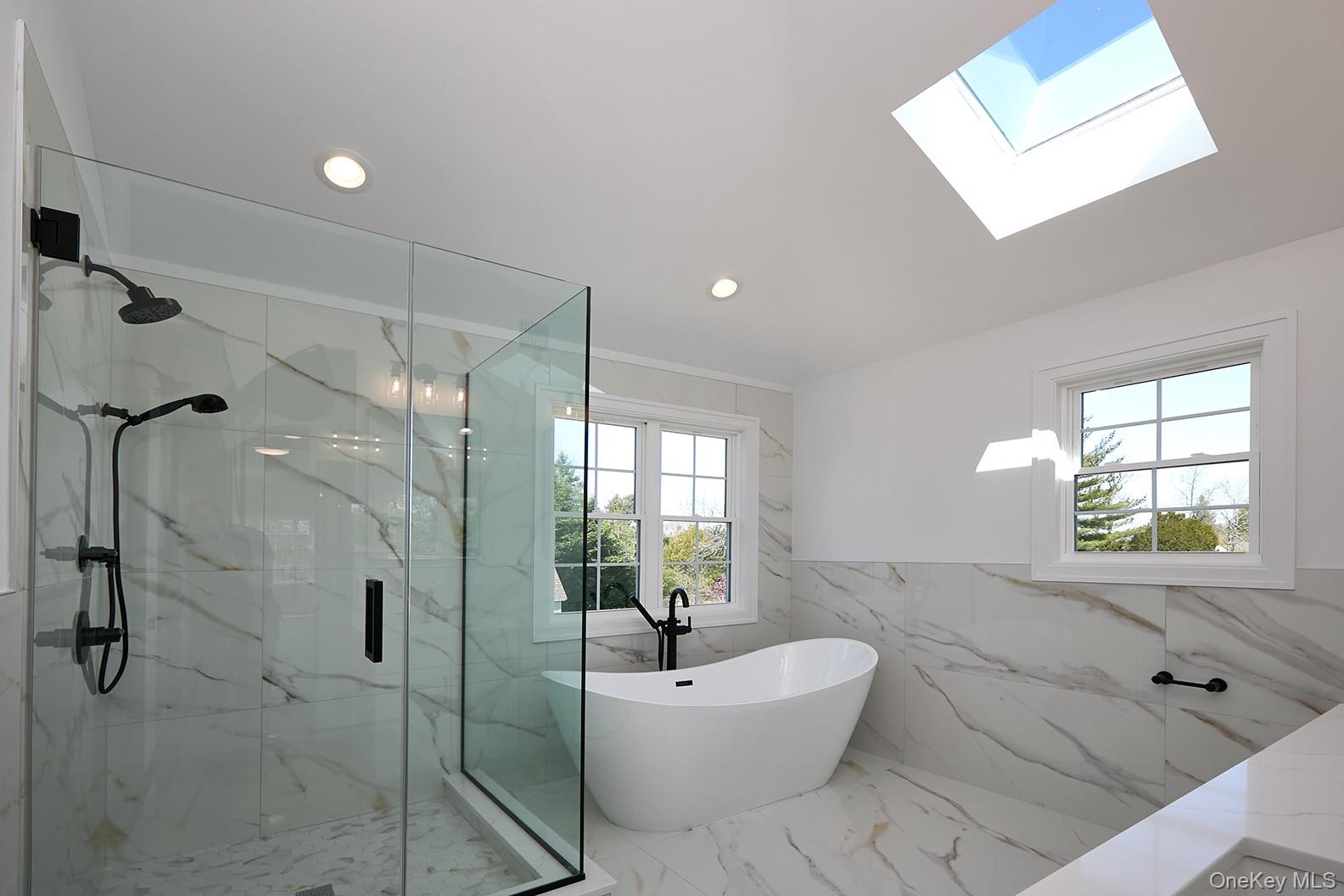 1480 Adam Place Wantagh, NY 11793 - Photo 22 of 22 Bathroom with marble tiled floors, tile walls, a marble finish shower, a soaking tub, and recessed lighting