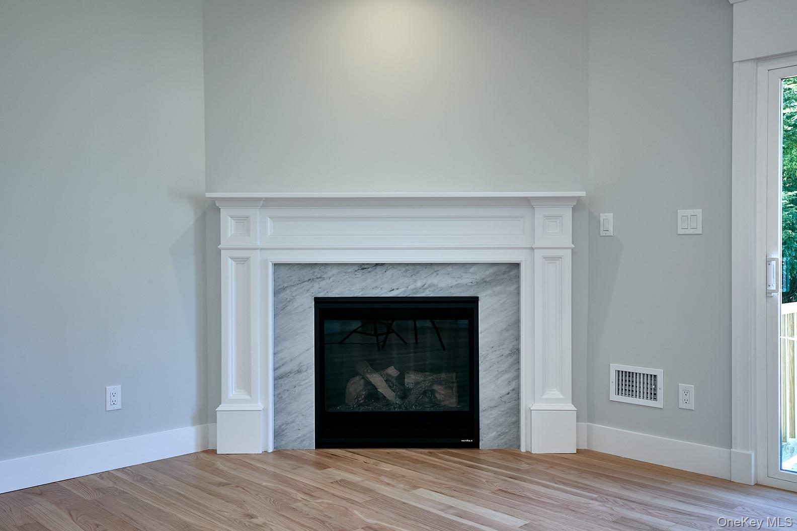 1480 Adam Place Wantagh, NY 11793 - Photo 10 of 22 Detailed view of wood finished floors and a high end fireplace