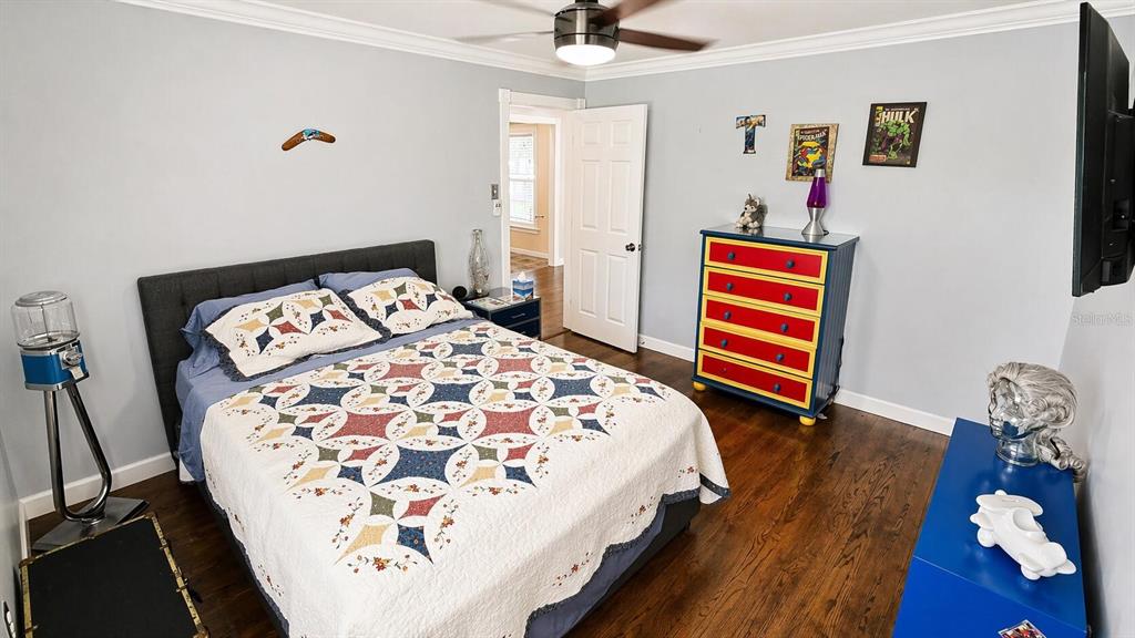 2313 Southeast 7th Street Ocala, FL 34471 - Photo 15 of 54 a bedroom with a bed and a chandelier
